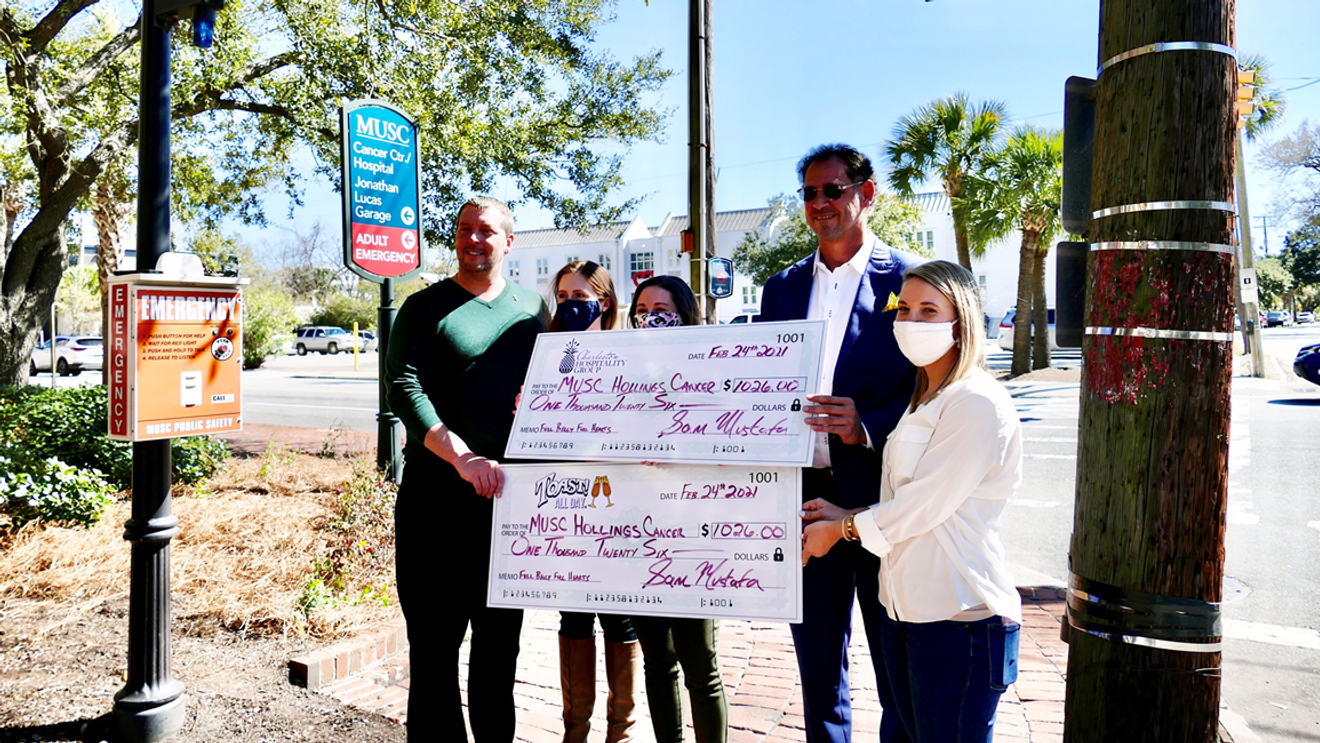 Charleston restaurateur, Sam Mustafa, presents two checks, totaling over $2,000 to the MUSC Hollings Cancer Center in honor of Breast Cancer Awareness month.